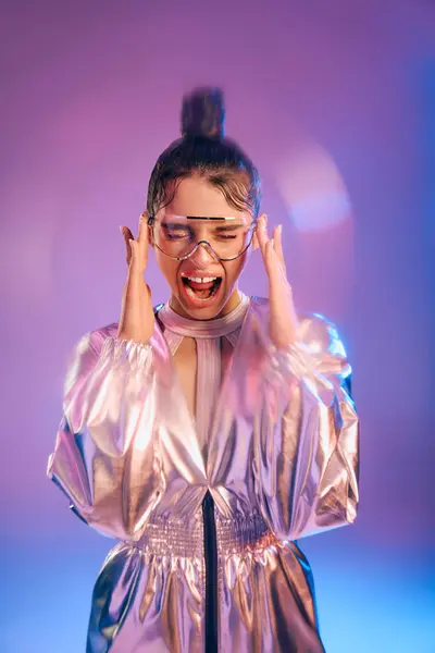 A stylish woman in holographic attire radiates joy and vibrant colors. — Stock Photo