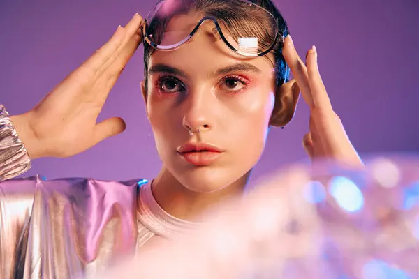 A stylish woman in futuristic attire showcases holographic colors with confidence and beauty. — Stock Photo
