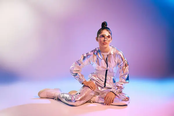 In a vibrant space, a young woman showcases a holographic outfit, radiating modern fashion trends. — Stock Photo