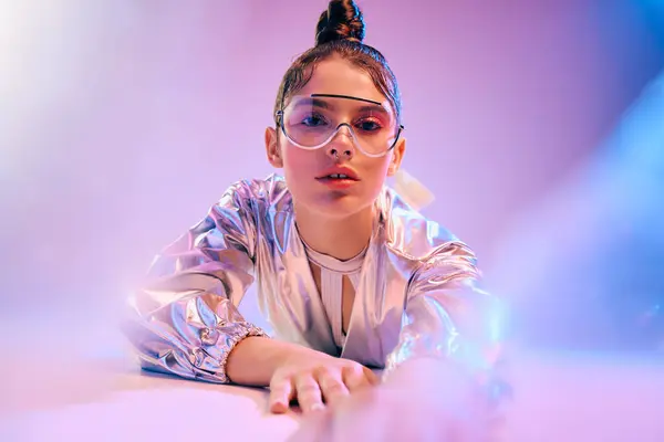 A young woman shows off a striking futuristic look in vibrant holographic attire. — Stock Photo