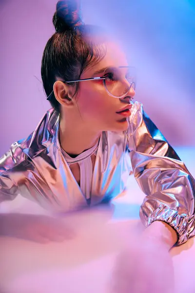 A young woman in holographic clothing engages with her surroundings, radiating confidence. — Stock Photo