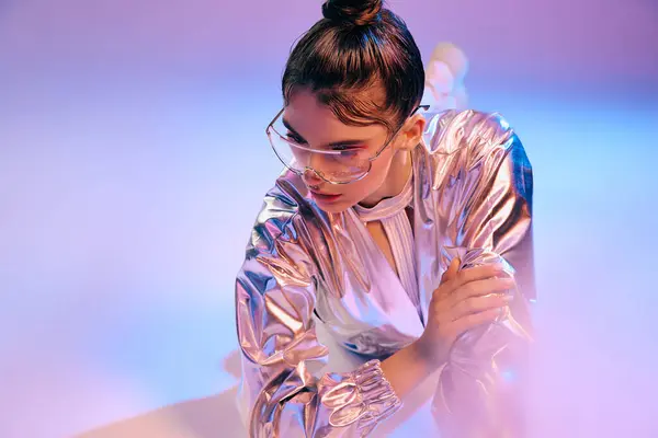 A young woman shines in bold metallic fashion with vibrant holographic hues. — Stock Photo