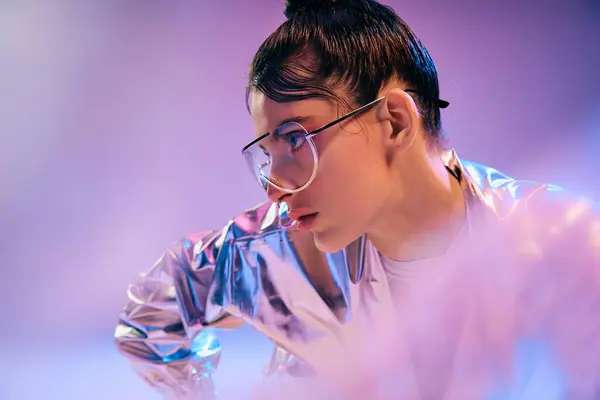 A young woman displays vibrant holographic fashion, highlighting modern style. — Stock Photo
