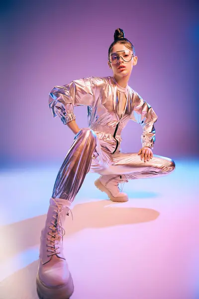 Futuristic woman poses in metallic attire, highlighted by holographic colors and modern boots. — Stock Photo