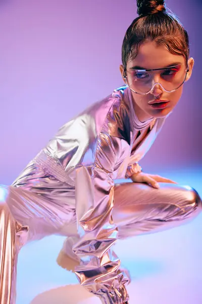 Young woman in metallic outfit poses with holographic colors in a modern setting. — Stock Photo