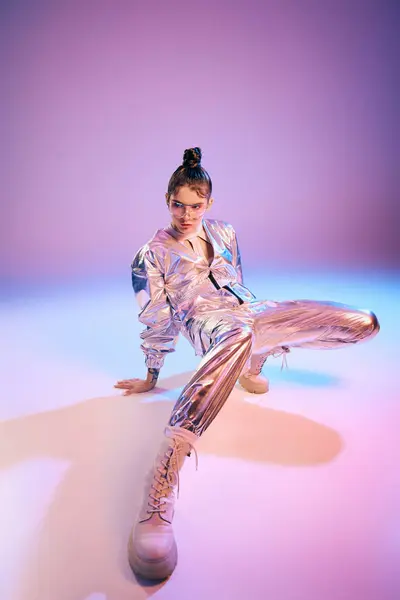 Vibrant holographic outfit highlights a confident young woman posing stylishly in a modern setting. — Stock Photo