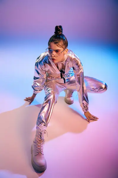 A stylish woman poses in vibrant holographic attire against a colorful backdrop. — Stock Photo