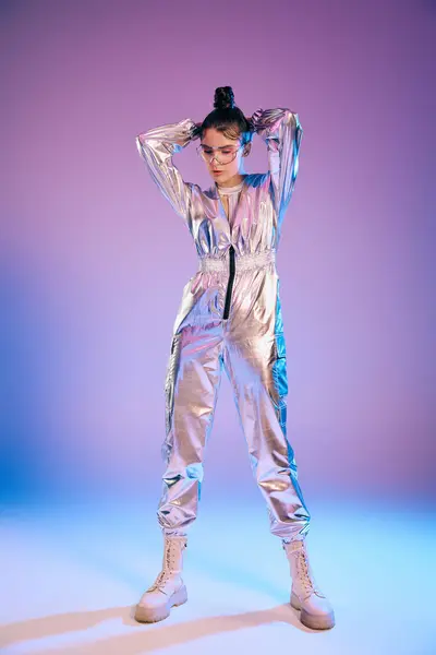 A young woman stands confidently in futuristic attire with holographic colors and a modern vibe. — Stock Photo