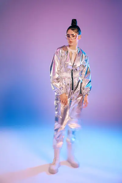 A young woman in a metallic outfit exudes confidence and modern style in a vibrant scene. — Stock Photo