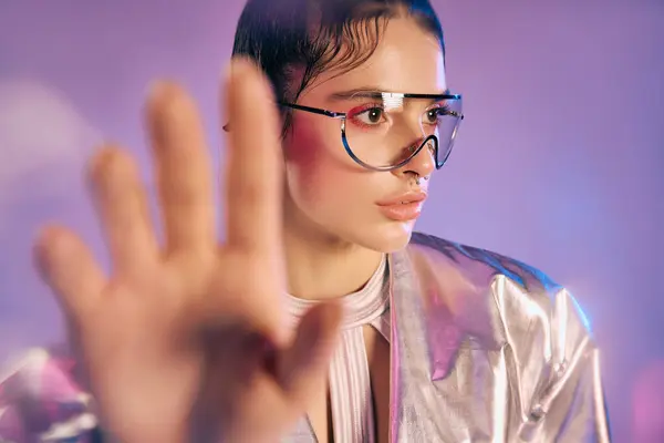 A stylish woman in futuristic attire radiates holographic colors and confidence. — Stock Photo