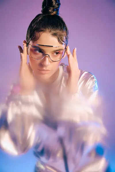 A young woman showcases her futuristic style with holographic colors and trendy accessories. — Stock Photo