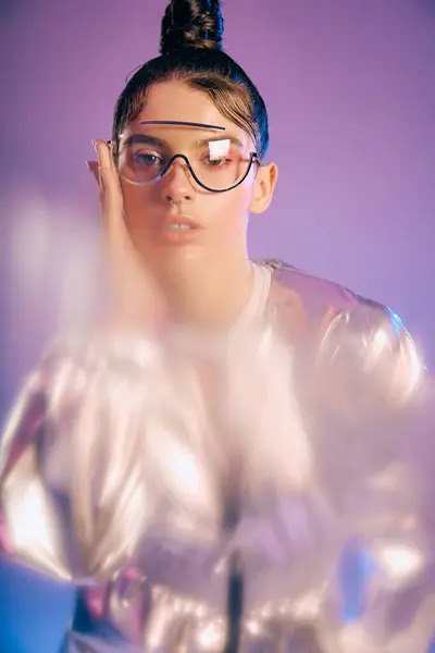 A young woman flaunts her beauty in holographic attire, radiating confidence and style. — Stock Photo