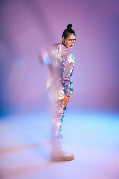 A young woman in futuristic attire exudes confidence and style in a vibrant setting. — Stock Photo