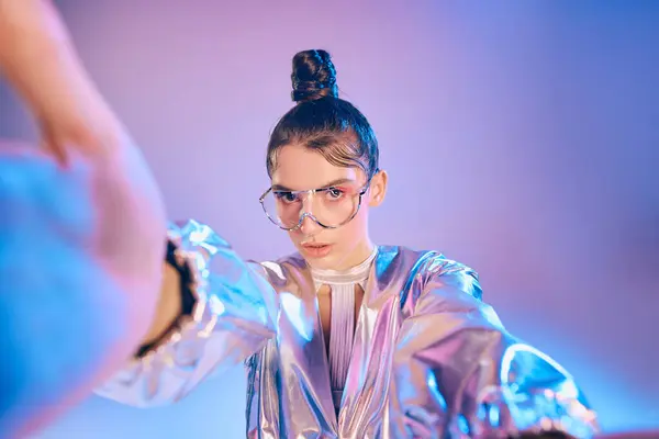 A young woman flaunts her bold, holographic futuristic outfit and accessories. — Stock Photo
