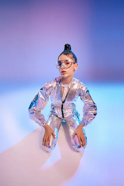 A young woman flaunts her holographic outfit in a stylish pose within a futuristic backdrop. — Stock Photo