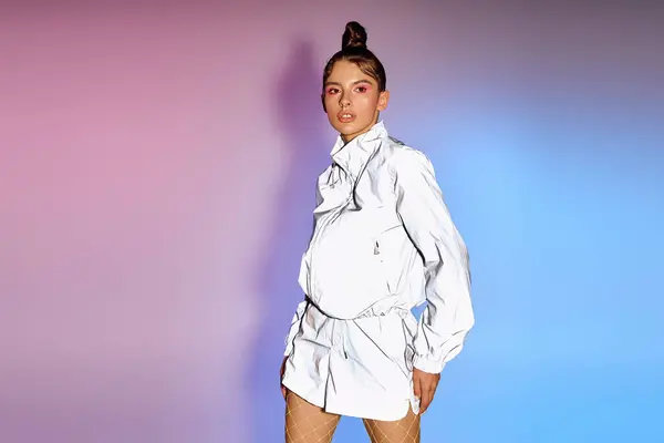 A young woman confidently poses in trendy attire amid a colorful holographic setting. — Stock Photo