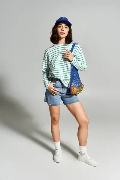 Charming woman embraces summer fashion, showcasing a trendy outfit and playful attitude. — Stock Photo