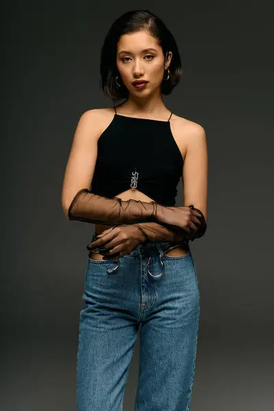 Fashion forward woman showcases her unique style with a confident pose and modern attire. — Stock Photo