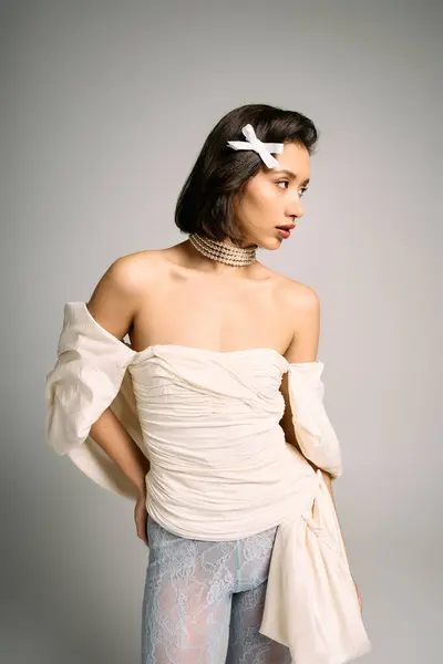 Young bride poses gracefully, attireed in an elegant gown with delicate accessories, radiating joy. — Stock Photo