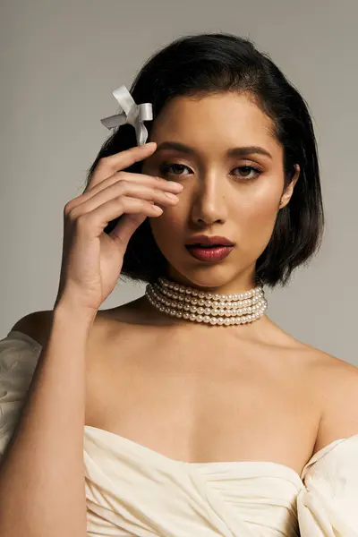 A young bride enchants with elegance, attireed in exquisite attire that highlights her grace. — Stock Photo