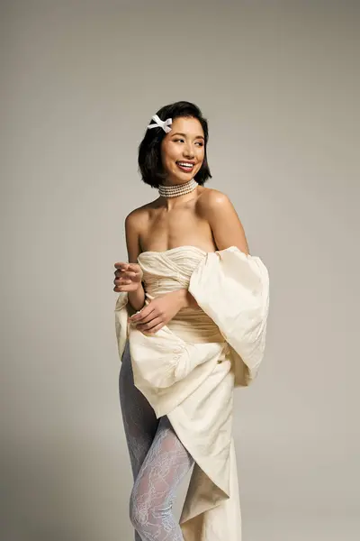 A beautiful bride smiles, showcasing her stunning wedding outfit and accessories in soft light. — Stock Photo