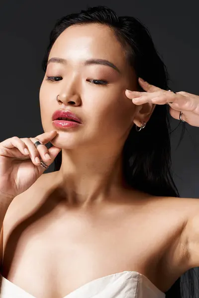 A graceful young woman poses, showcasing her features with a serene expression. — Stock Photo