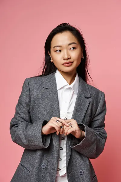 Young asian woman exudes charm and sophistication while showcasing her fashion choices indoors. — Stock Photo