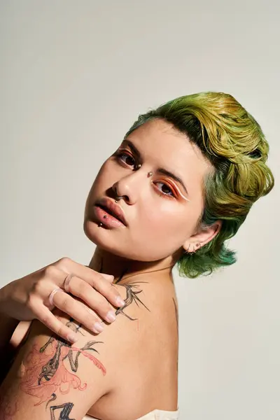 A young woman with vibrant green and yellow hair shows off her unique style and makeup. — Stock Photo