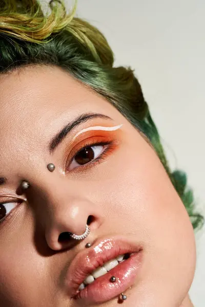 A young woman with vibrant green hair showcases her stylish makeup and accessories in a shoot. — Stock Photo