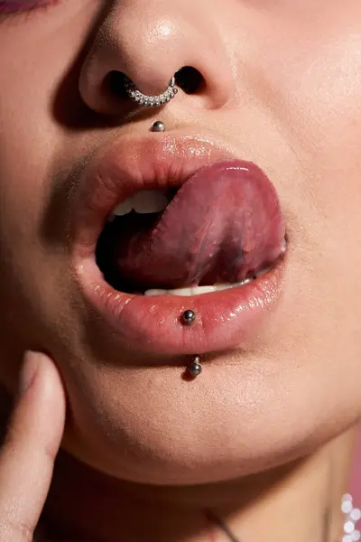 Close up of a stunning young woman with vibrant makeup and stylish piercings. — Stock Photo