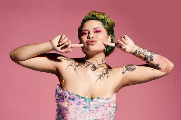 Confident young woman shows off stylish fashion and bold makeup against a pink backdrop. — Stock Photo
