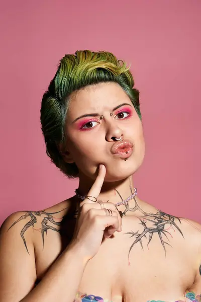 A confident young woman displays her unique fashion and beauty against a pink backdrop. — Stock Photo