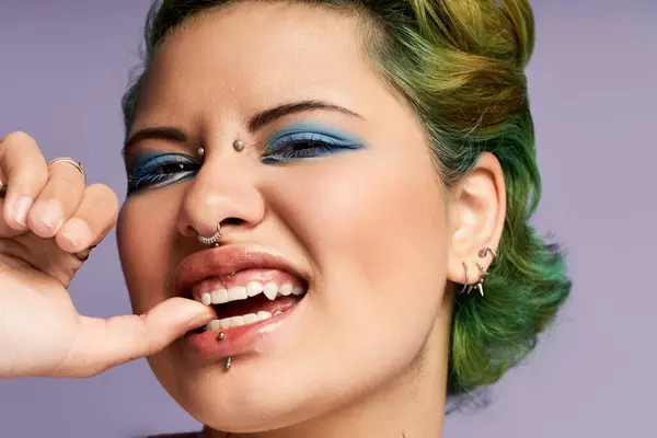 A young woman expresses her stylishness with vibrant makeup while smiling gracefully. — Stock Photo