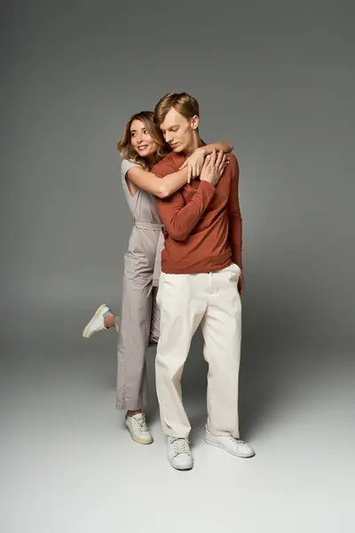 Young couple showcases spring fashion in a studio, radiating love and style together. — Stock Photo