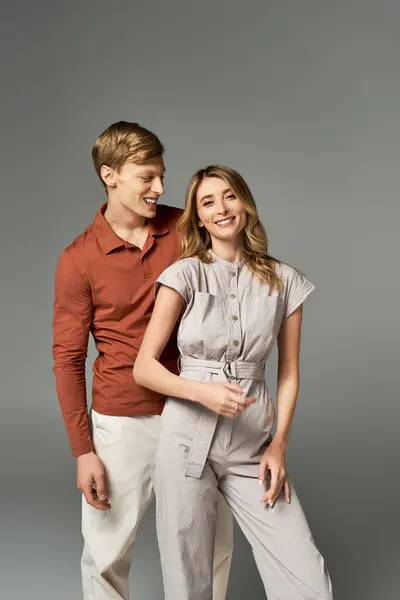 A young couple showcases their spring fashion, exuding joy and style in a studio setting. — Stock Photo