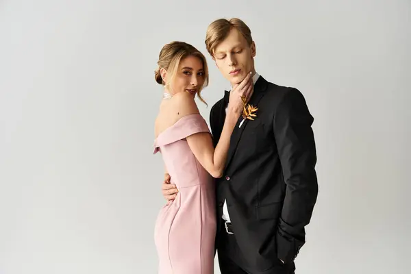 Pareja comparte un momento de intimidad durante su boda de primavera, vestida elegantemente para la ocasión. - foto de stock