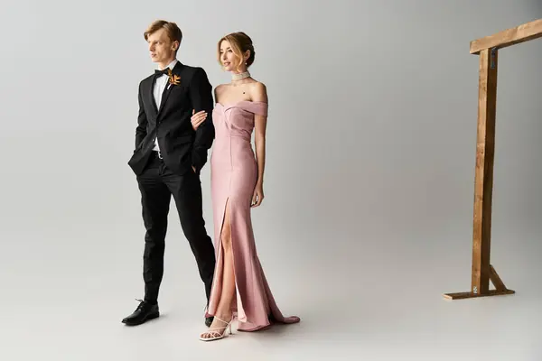 A young couple enjoys a spring wedding with the bride in a lovely pink dress and groom beside her. — Stock Photo