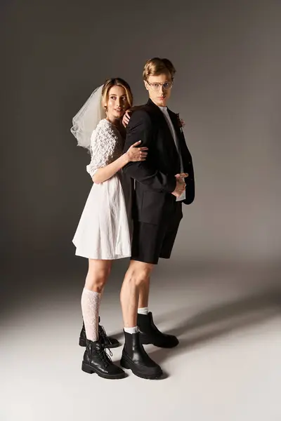 A young couple stands confidently together, showcasing their creativity on their wedding day. — Stock Photo