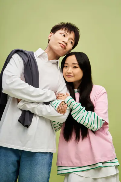 A lovely couple stands close, radiating affection and style in a vibrant atmosphere. — Stock Photo