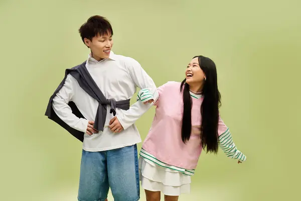 A lovely couple shares a joyful moment, showcasing their stylish outfits and playful chemistry. — Stock Photo