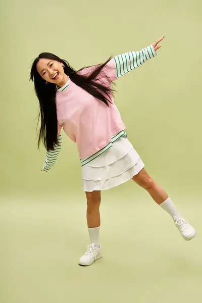 Stylish young woman in vivid casual attire posing cheerfully. — Stock Photo