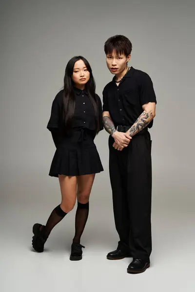 A fashionable couple stands confidently in a stylish studio, radiating elegance. — Stock Photo