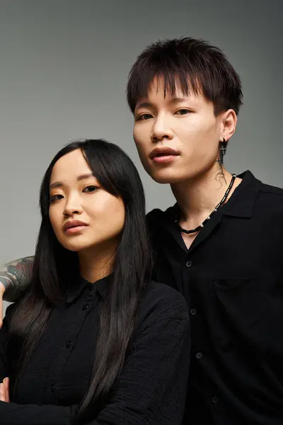 Charming couple in a modern studio displays their stylish outfits and strong bond. — Stock Photo