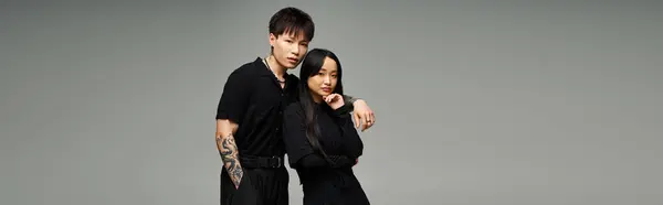 A stylish couple exudes love and romance with their chic outfits and confident poses. — Stock Photo