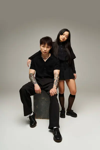 A lovely couple showcases their fashion sense and strong connection in a chic studio setting. — Stock Photo