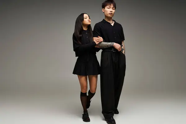 A stylish couple poses closely in a chic studio, showcasing love and fashion through their looks. — Stock Photo