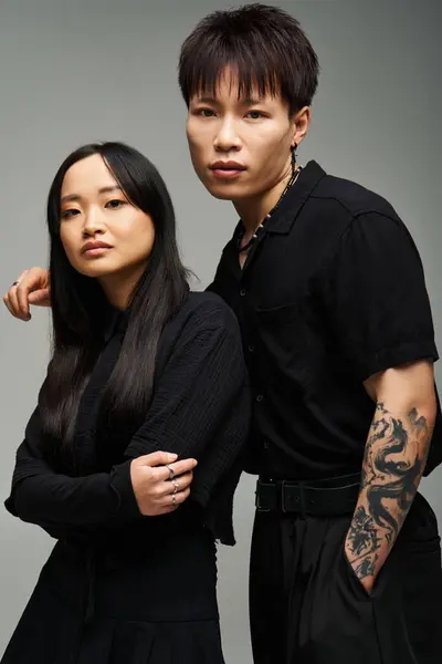 A stylish couple poses closely, highlighting their unique fashion in a stunning studio. — Stock Photo