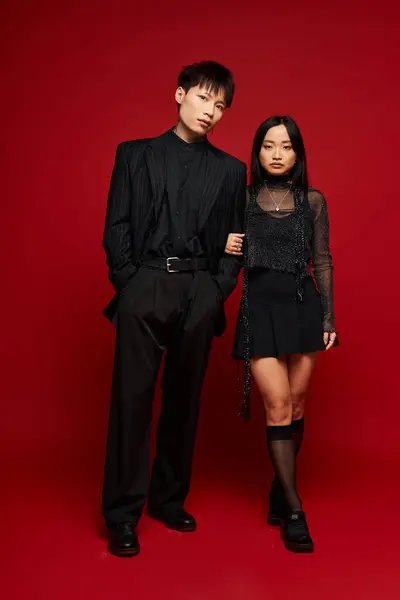 Charming duo showcases fashion forward outfits in a romantic pose, radiating connection and style. — Stock Photo