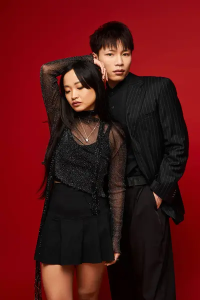 A fashionable couple exudes charm and connection, dressed elegantly for a stylish evening event. — Stock Photo
