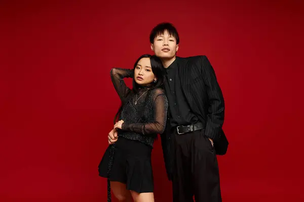 Charming couple exuding love and style while striking a fashionable pose in a modern studio. — Stock Photo